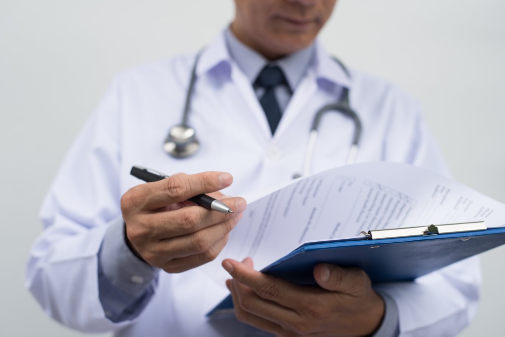 Male doctor reading a patient